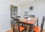 Thumbnail 40 of 54 - a dining room with a wooden table and chairs