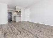 Thumbnail 48 of 54 - the living room and kitchen of an apartment with wood flooring