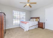 Thumbnail 41 of 54 - a bedroom with a bed and a ceiling fan