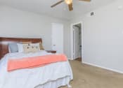 Thumbnail 42 of 54 - a bedroom with a bed and a ceiling fan