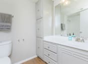 Thumbnail 43 of 54 - a bathroom with a toilet and a sink and a mirror