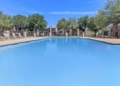 Thumbnail 54 of 54 - a large swimming pool with trees and apartments in the background