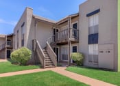 Thumbnail 20 of 54 - the exterior of an apartment building with stairs and grass