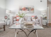 Thumbnail 22 of 54 - a living room with a couch and a table