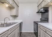 Thumbnail 51 of 54 - a kitchen with white cabinets and a sink and a stove