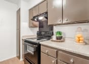 Thumbnail 29 of 54 - a kitchen with stainless steel appliances and granite counter tops