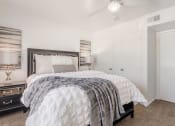Thumbnail 33 of 54 - a bedroom with a bed and a ceiling fan