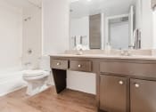 Thumbnail 34 of 54 - a bathroom with a toilet and a sink and a mirror