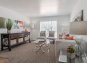 Thumbnail 25 of 54 - a living room with a couch and a table