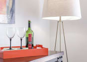 Thumbnail 26 of 54 - a bottle of wine on a table with glasses and a lamp