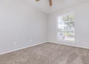 Thumbnail 52 of 54 - an empty room with carpet and a window