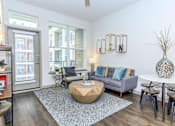 Thumbnail 5 of 28 - a living room with a couch and a round coffee table
