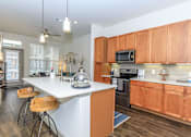Thumbnail 23 of 28 - a kitchen with wooden cabinets and a white counter top