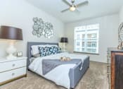 Thumbnail 6 of 28 - a bedroom with a bed and a ceiling fan