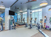 Thumbnail 20 of 28 - a gym with treadmills and other exercise equipment and windows