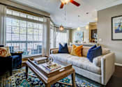 Thumbnail 28 of 40 - a living room with a couch and a coffee table