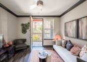 Thumbnail 54 of 54 - a living room with a couch and a door to a balcony