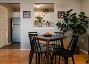 Thumbnail 2 of 35 - a dining room with a table and chairs and a refrigerator