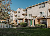 Thumbnail 7 of 35 - an apartment building with a yard and green grass