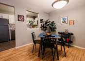 Thumbnail 5 of 35 - a dining room with a table and chairs and a kitchen