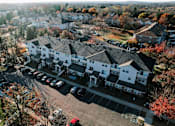 Thumbnail 13 of 35 - a aerial view of a neighborhood with houses and cars