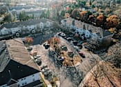 Thumbnail 19 of 35 - an aerial view of a neighborhood with houses and cars