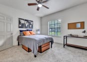 Thumbnail 6 of 14 - a bedroom with a bed and a ceiling fan