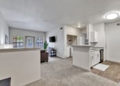 Thumbnail 2 of 14 - the living room and kitchen of an apartment with a view of the dining room and
