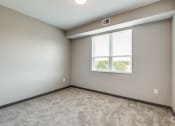 Thumbnail 7 of 26 - an empty room with a window and carpet