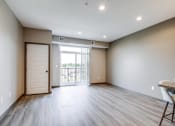 Thumbnail 6 of 26 - an empty living room with a door to a balcony