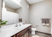 Thumbnail 8 of 26 - a bathroom with a sink and a toilet and a mirror