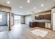 Thumbnail 5 of 26 - an open kitchen and living room with a door to a balcony