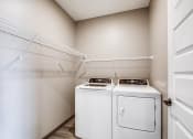 Thumbnail 9 of 26 - a laundry room with washer and dryer in it