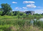 Thumbnail 27 of 27 - a building with a crane in front of a body of water