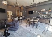 Thumbnail 12 of 27 - a dining room with tables and chairs and a kitchen