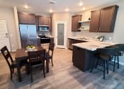 Thumbnail 3 of 27 - a kitchen and dining area with a table and chairs