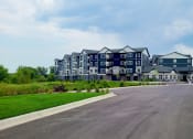 Thumbnail 26 of 27 - a large building with a road in front of it