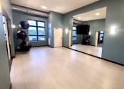 Thumbnail 10 of 27 - an empty room with paintings on the wall and a wooden floor
