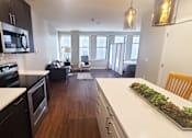 Thumbnail 35 of 39 - A kitchen with black cabinets and a white countertop.