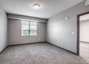 Thumbnail 12 of 26 - an empty room with a window and a door