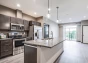 Thumbnail 2 of 26 - a kitchen with stainless steel appliances and a granite counter top
