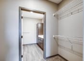 Thumbnail 10 of 26 - a spacious closet with a mirrored door and a walk in closet