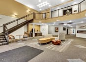 Thumbnail 5 of 24 - the lobby of a building with a staircase and couches