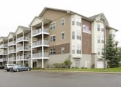 Thumbnail 28 of 28 - a picture of an apartment complex with cars parked in front of it