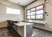 Thumbnail 14 of 26 - Community room with a bar height counter top and seating plus a window