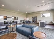 Thumbnail 13 of 26 - Community Room with a couch and tables and a kitchen
