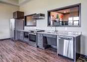 Thumbnail 15 of 26 - Community room  kitchen with stainless steel appliances and a counter top