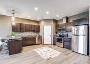 Thumbnail 4 of 26 - a kitchen with stainless steel appliances and wooden cabinets