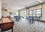 Thumbnail 7 of 25 - A room with a pool table and chairs.