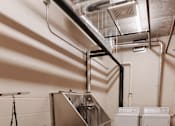 Thumbnail 18 of 37 - a large stainless steel machine in a room with other appliances